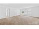 This bedroom features three windows and a large closet with white walls and carpet at 2007 Lydney Cir, Waxhaw, NC 28173