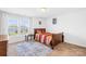 Cozy bedroom displaying a wood bed frame, a window, and a rug on the carpet at 2007 Lydney Cir, Waxhaw, NC 28173