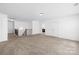 Bright bonus room with neutral carpet, white walls, and staircase at 2007 Lydney Cir, Waxhaw, NC 28173