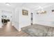 Formal dining room featuring a decorative light fixture, wood floors, and a large area rug at 2007 Lydney Cir, Waxhaw, NC 28173