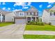 Inviting two-story home boasting a manicured lawn, brick facade, and attached two-car garage at 2007 Lydney Cir, Waxhaw, NC 28173
