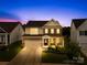 Inviting two-story home with brick accents, well-manicured lawn, and attached two-car garage during twilight at 2007 Lydney Cir, Waxhaw, NC 28173