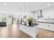 Modern kitchen with stainless steel appliances, island, and an adjacent dining area at 2007 Lydney Cir, Waxhaw, NC 28173