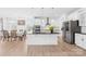 Well-lit kitchen with stainless steel appliances and a modern island at 2007 Lydney Cir, Waxhaw, NC 28173