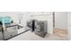 Modern laundry room with gray washer and dryer, dark countertop, and upper white cabinets at 2007 Lydney Cir, Waxhaw, NC 28173