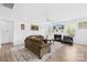 Spacious living room with wood floors, large windows, a fireplace, and a ceiling fan at 2007 Lydney Cir, Waxhaw, NC 28173