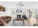 Cozy living room with a fireplace, large windows, and a ceiling fan at 2007 Lydney Cir, Waxhaw, NC 28173
