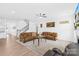 Spacious living room featuring two sofas, a ceiling fan, and stairs to the second floor at 2007 Lydney Cir, Waxhaw, NC 28173