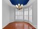 Bright dining room with hardwood floors, plantation shutters and a decorative chandelier at 2106 Yellowstone Dr, Fort Mill, SC 29707