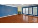 Elegant living room with fireplace, hardwood floors, and large windows offering plenty of natural light at 2106 Yellowstone Dr, Fort Mill, SC 29707