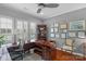 Well-lit home office with custom desk, hardwood floors, and wall shelving at 2106 Yellowstone Dr, Fort Mill, SC 29707