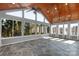 Bright sunroom featuring large windows, a wood-paneled ceiling, ceiling fans, and stone flooring at 2106 Yellowstone Dr, Fort Mill, SC 29707