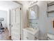 Bright bathroom featuring a classic white vanity, mirrored cabinet, and convenient towel rack at 2110 Winter St, Charlotte, NC 28205