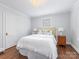 Bright bedroom with hardwood floors featuring a cozy bed, bedside tables, and natural light at 2110 Winter St, Charlotte, NC 28205