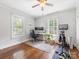 Bright bedroom with natural light featuring a ceiling fan, desk area, and exercise bike at 2110 Winter St, Charlotte, NC 28205