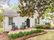 Charming white brick home featuring a cozy front porch with rocking chairs and manicured landscaping at 2110 Winter St, Charlotte, NC 28205