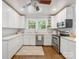 Bright kitchen features stainless steel appliances, wood floors, and double windows at 2110 Winter St, Charlotte, NC 28205