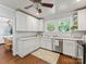 Bright kitchen features stainless steel appliances, wood floors, and double windows at 2110 Winter St, Charlotte, NC 28205