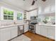 Bright kitchen features stainless steel appliances, quartz countertops, and double windows at 2110 Winter St, Charlotte, NC 28205