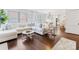 Bright living room with hardwood floors, white sectional sofa, and large windows bringing in natural light at 2110 Winter St, Charlotte, NC 28205
