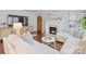 Bright living room with hardwood floors, white sectional sofa, a fireplace, and tv at 2110 Winter St, Charlotte, NC 28205