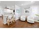 Bright living room features a bar, white armchairs, hardwood floors, and a window at 2110 Winter St, Charlotte, NC 28205