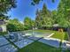 Beautiful backyard featuring a modern pool, lounge seating, and lush greenery at 2121 Club Rd, Charlotte, NC 28205