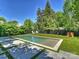Lush backyard featuring a pool, lounge seating, and privacy fencing at 2121 Club Rd, Charlotte, NC 28205