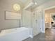 Modern bathroom featuring a glass-enclosed shower, a standalone tub, and contemporary finishes at 2121 Club Rd, Charlotte, NC 28205
