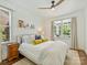 Cozy bedroom with a ceiling fan, white bedding, and natural light filtering through the window at 2121 Club Rd, Charlotte, NC 28205