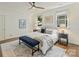Elegant bedroom featuring a comfortable bed, blue bench, and natural light streaming through the windows at 2121 Club Rd, Charlotte, NC 28205