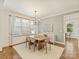 Elegant dining room with a modern chandelier, hardwood floors, and ample natural light for enjoyable meals at 2121 Club Rd, Charlotte, NC 28205