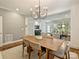 Bright dining room with a large table, stylish chandelier, and an open view into the inviting living room at 2121 Club Rd, Charlotte, NC 28205