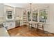 Bright kitchen featuring white cabinetry, stainless steel appliances, hardwood floors and eat-in dining area with great natural light at 2121 Club Rd, Charlotte, NC 28205