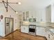 Modern kitchen with stainless steel appliances, white cabinets, hardwood floors, and ample counter space for cooking at 2121 Club Rd, Charlotte, NC 28205