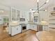 Beautiful, updated kitchen with white cabinets, stainless steel appliances, hardwood floors, and modern light fixture at 2121 Club Rd, Charlotte, NC 28205