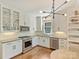 Well-appointed kitchen featuring stainless steel appliances, white cabinets, hardwood floors, and modern light fixture at 2121 Club Rd, Charlotte, NC 28205