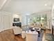 Spacious living room featuring hardwood floors, modern decor, and an open layout for seamless entertaining at 2121 Club Rd, Charlotte, NC 28205
