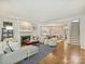 Bright living room with a fireplace, hardwood floors, and an open layout leading to the dining area at 2121 Club Rd, Charlotte, NC 28205