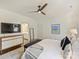 Bright main bedroom featuring a ceiling fan, accent wall art, and an ensuite bathroom at 2121 Club Rd, Charlotte, NC 28205