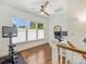 Well-lit office with multiple windows, hardwood floors, and exercise equipment ideal for working and staying active at 2121 Club Rd, Charlotte, NC 28205
