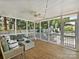 Inviting screened porch with ample seating, ceiling fan, and views of the backyard at 2121 Club Rd, Charlotte, NC 28205