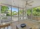 Comfortable screened porch with a ceiling fan and views of the backyard and pool at 2121 Club Rd, Charlotte, NC 28205