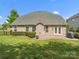 Well-maintained backyard with patio, manicured lawn, privacy shrubs, and fenced perimeter at 2467 Chatham Dr, Fort Mill, SC 29707