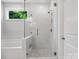 Bright bathroom featuring a glass enclosed shower, soaking tub, and tile flooring at 2467 Chatham Dr, Fort Mill, SC 29707