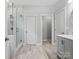 Bright bathroom with glass shower, vanity with sink, tile floors and separate toilet area at 2467 Chatham Dr, Fort Mill, SC 29707