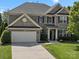 Two-story brick home with a well-manicured lawn, two-car garage, and beautiful landscaping at 2467 Chatham Dr, Fort Mill, SC 29707