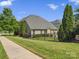 Exterior home view featuring a well-manicured lawn and private fenced backyard at 2467 Chatham Dr, Fort Mill, SC 29707