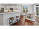 Bright kitchen area featuring white cabinets and stainless steel appliances, and a bar with stools at 2467 Chatham Dr, Fort Mill, SC 29707