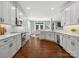 Modern kitchen with white cabinets, stainless steel appliances, and hardwood floors, open to the dining area at 2467 Chatham Dr, Fort Mill, SC 29707